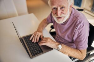 Elderly gentleman using a laptop